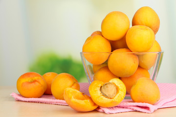 Fresh natural apricot in bowl on table in kitchen