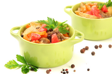 Homemade beef stir fry with vegetables in color pans, isolated