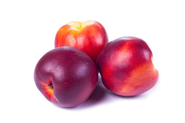 Fresh nectarines on a white background.