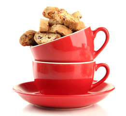 Tasty cookies in cups isolated on white