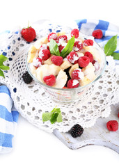 Fruit salad in glass bowl, isolated on white