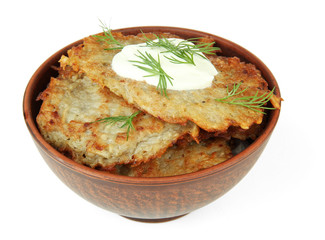 Potato pancakes in bowl, isolated on white