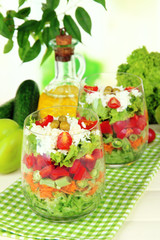 Tasty salad with fresh vegetables on wooden table