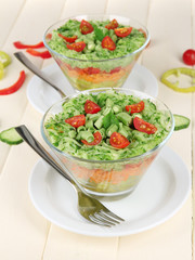 Tasty salad with fresh vegetables on wooden table