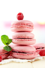 Gentle macaroons on table on light background