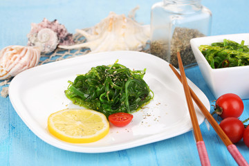 Sea kale on plate on wooden table close-up