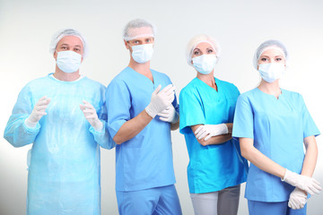 Surgeons standing on grey background