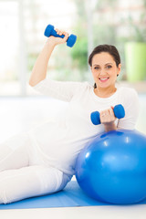 Fototapeta na wymiar young pregnant woman doing fitness exercise