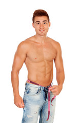 Fototapeta premium Men with perfect abs measuring his waist