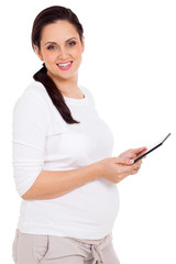 pregnant woman holding tablet computer