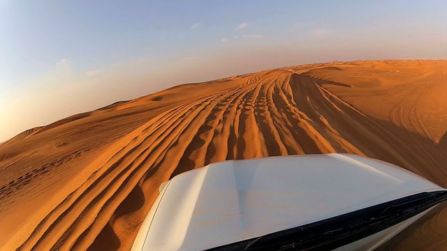 4x4 off road vehicle taking tourists on desert trip, Middle East