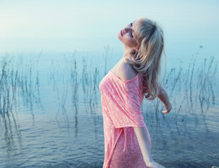 Sensual blonde girl enjoying cold lake water