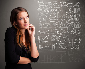 Pretty woman looking at stock market graphs and symbols