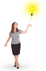 Happy woman holding a light bulb balloon