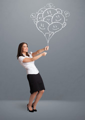 Happy woman holding smiling balloons drawing