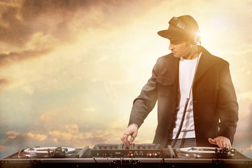DJ is playing by sunset