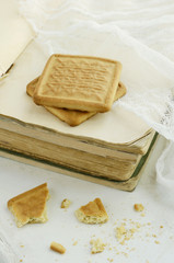 Two biscuits on vintage book pile