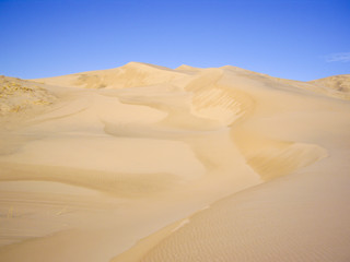 Fototapeta na wymiar Wet sand dunes after the rain