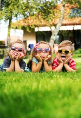 Foto op Canvas Trio kids showing their tongues © konradbak