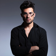 Obraz premium young fashion man holds glasses upside down