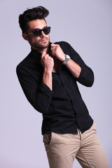 Fototapeta premium young fashion man fixing his shirt