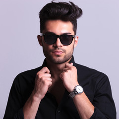 Obraz premium young fashion man with hands on collar