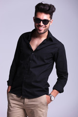 young fashion man smiles with hand in pocket