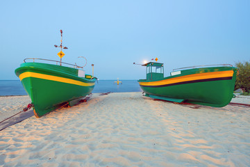 Green fishing boats on the beach of Baltic sea, Poland