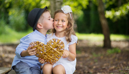 Great portrait of two kissing kids © konradbak