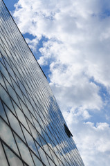 glass surface of a building with reflection of a cloud vertical
