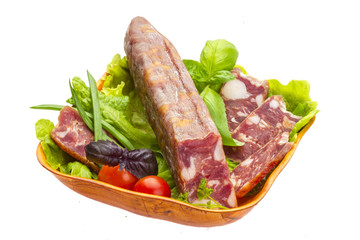 Ripe salami with salad, basil, onion and tomato