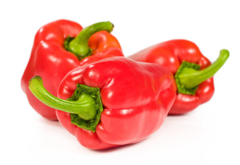 group of three red peppers