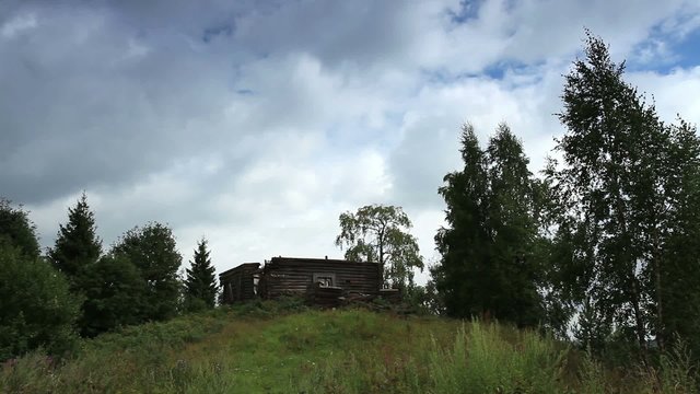Movement of clouds over the ruins of the old Russian wooden chur