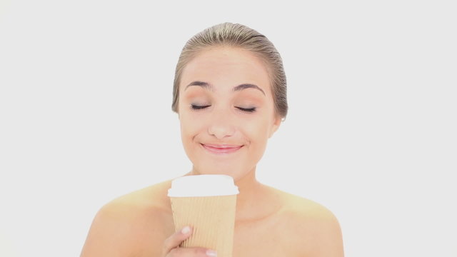 Beautiful model drinking from disposable cup