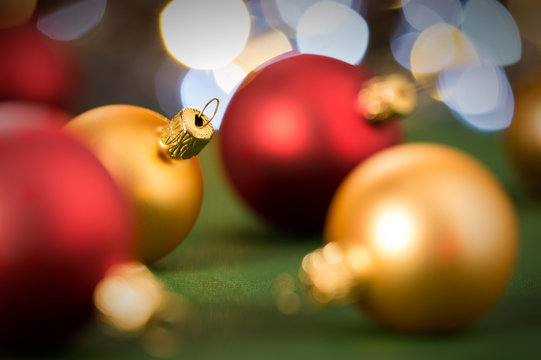 Gold And Red Christmas Baubles On Green