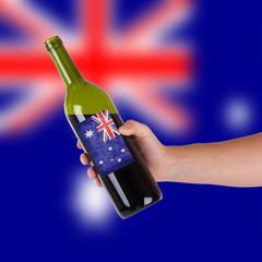 Hand holding a bottle of red wine