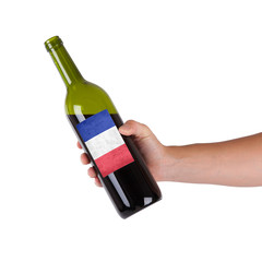 Hand holding a bottle of red wine