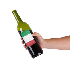 Hand holding a bottle of red wine