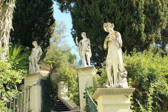 Garden Statues of male and female greek gods set in garden