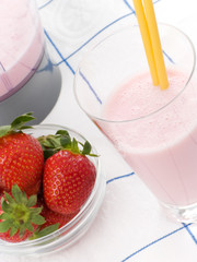 Smoothie made with strawberries in a table cloth.