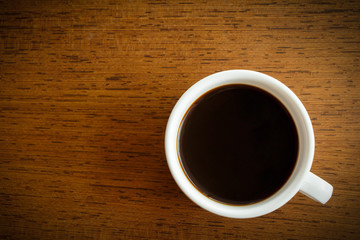 A cup of coffee on wooden background