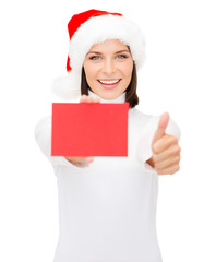 woman in santa helper hat with blank red card
