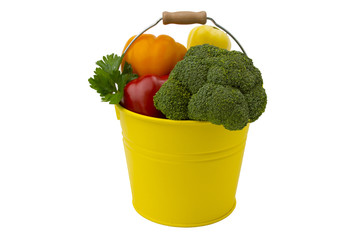 Vegetables in the yellow bucket isolated on the white background