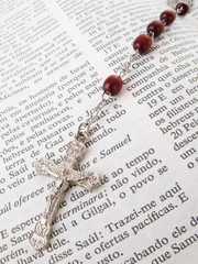 Rosary over an old holy bible