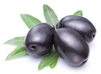 Three large black olives with leaves.