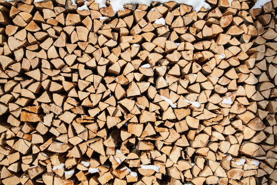 pile of firewood. snowy firewoods in winter forest