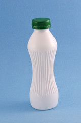 bottle of kefir or milk yougurt on blue background