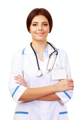 Fototapeta premium Beautiful young happy doctor over white background