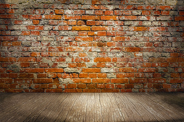 indoor background with red brick wall and wooden plank floor