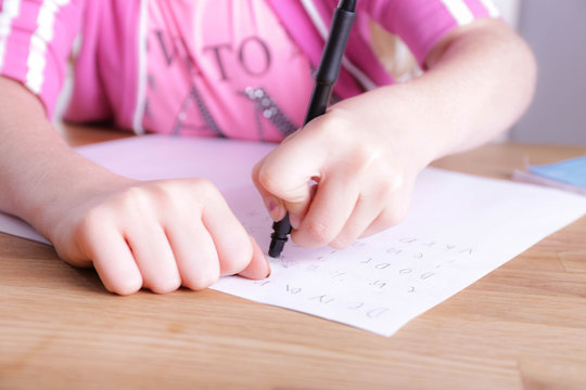 Girl using the eraser on a pen